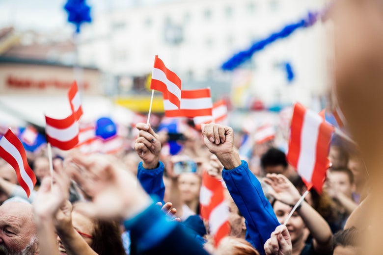 Supporters of the Austrian Freedom Party wave flags.