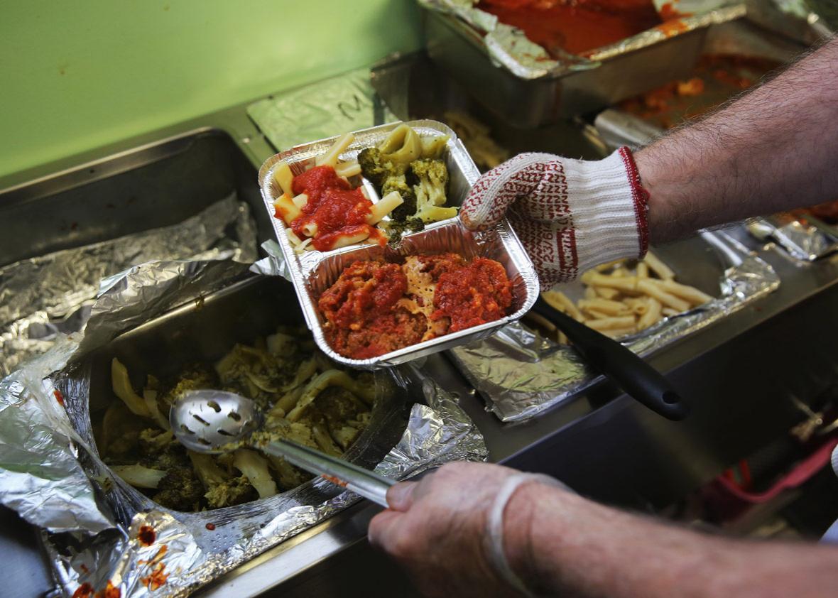 A Catholic Services worker prepares 'meals on wheels' lunch delivery on March 12, 2014 in Franklin, New Jersey. 