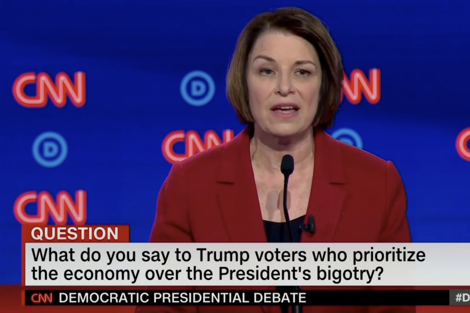 In this screengrab from CNN, Amy Klobuchar debates. The banner reads: “What do you say to Trump voters who prioritize the economy over the President's bigotry?”