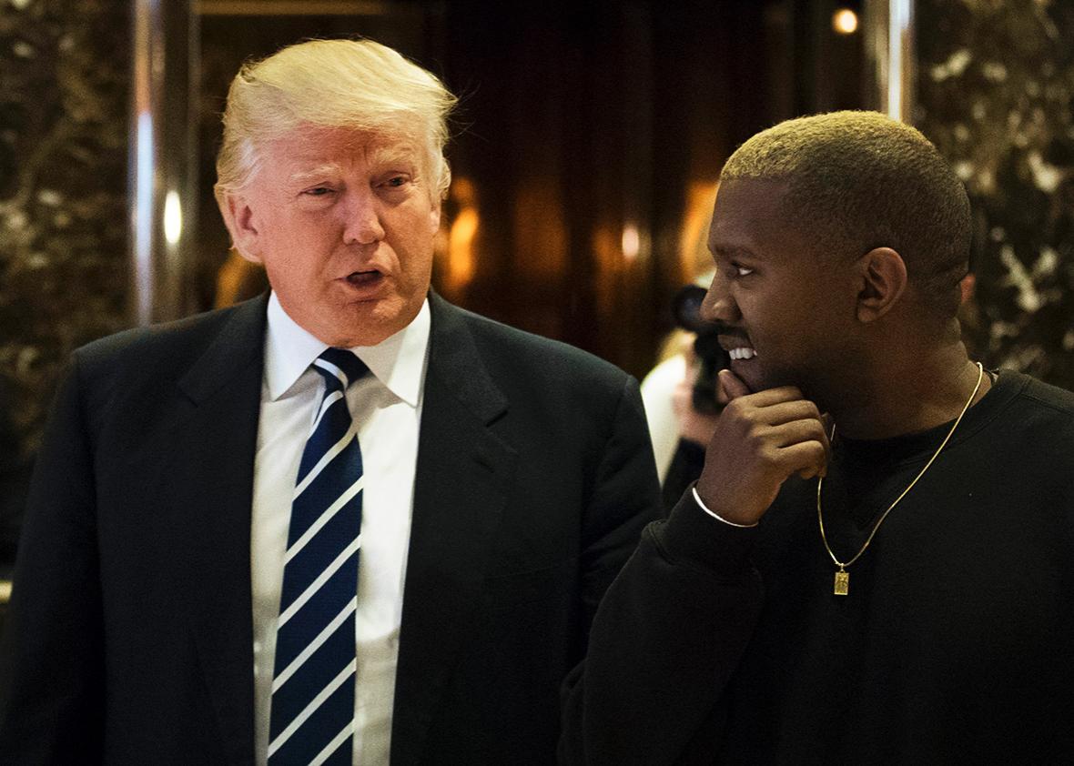 President-elect Donald Trump and Kanye West walk into the lobby at Trump Tower, December 13, 2016 in New York City. 