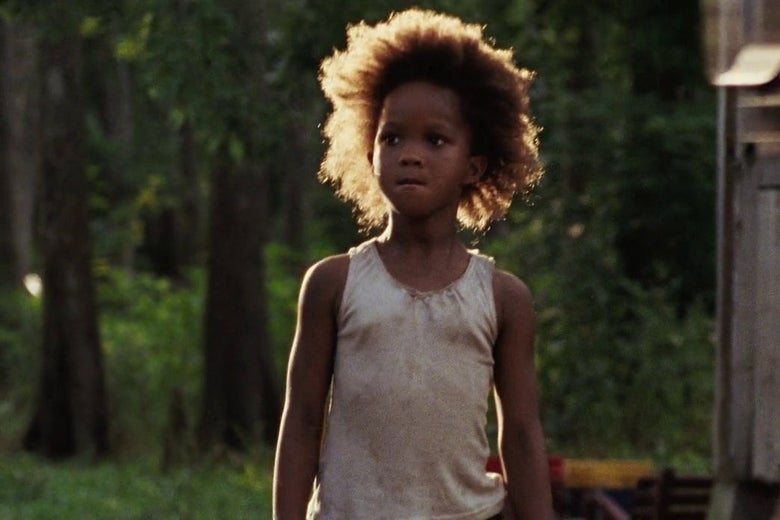 A young girl stands biting her lip in a dirty tank top in rural Louisiana