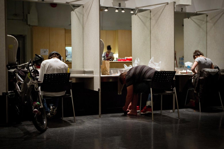 People sit in carrels while injecting drugs.