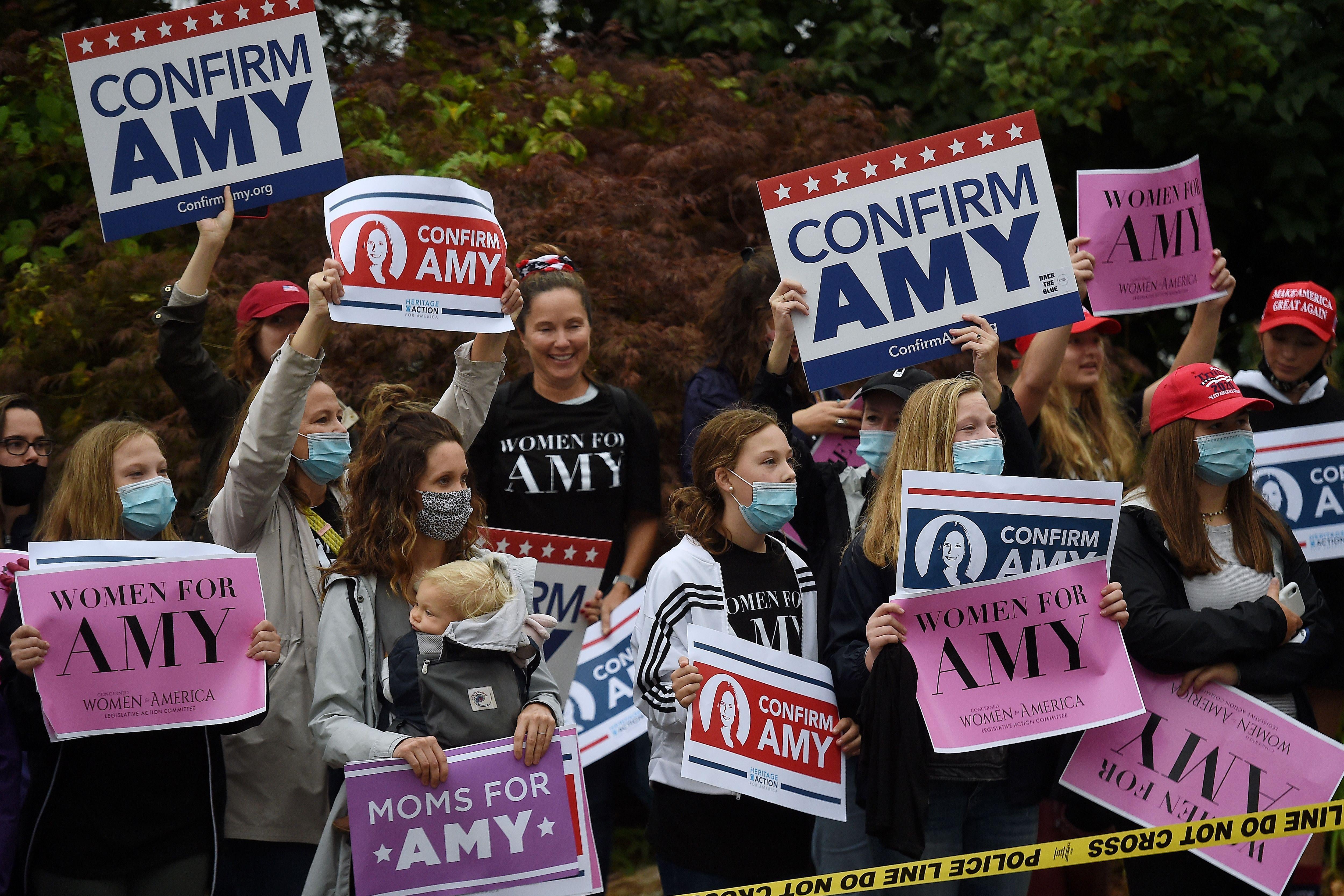 Supporters of President Donald Trump's Supreme Court nominee, Amy Coney Barrett gather in front of the Hart Senate building on the first day of her nomination hearing on October 12, 2020 in Washington, DC. (Photo by Olivier DOULIERY / AFP) (Photo by OLIVIER DOULIERY/AFP via Getty Images)