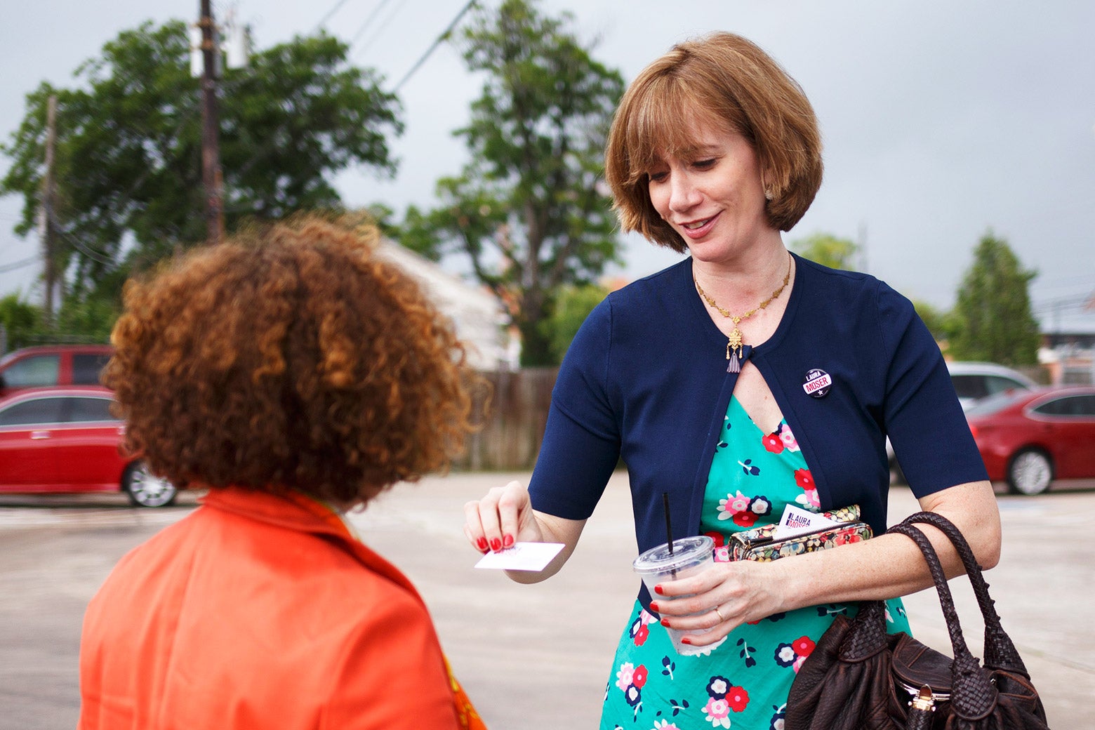 Laura Moser hands out a card.