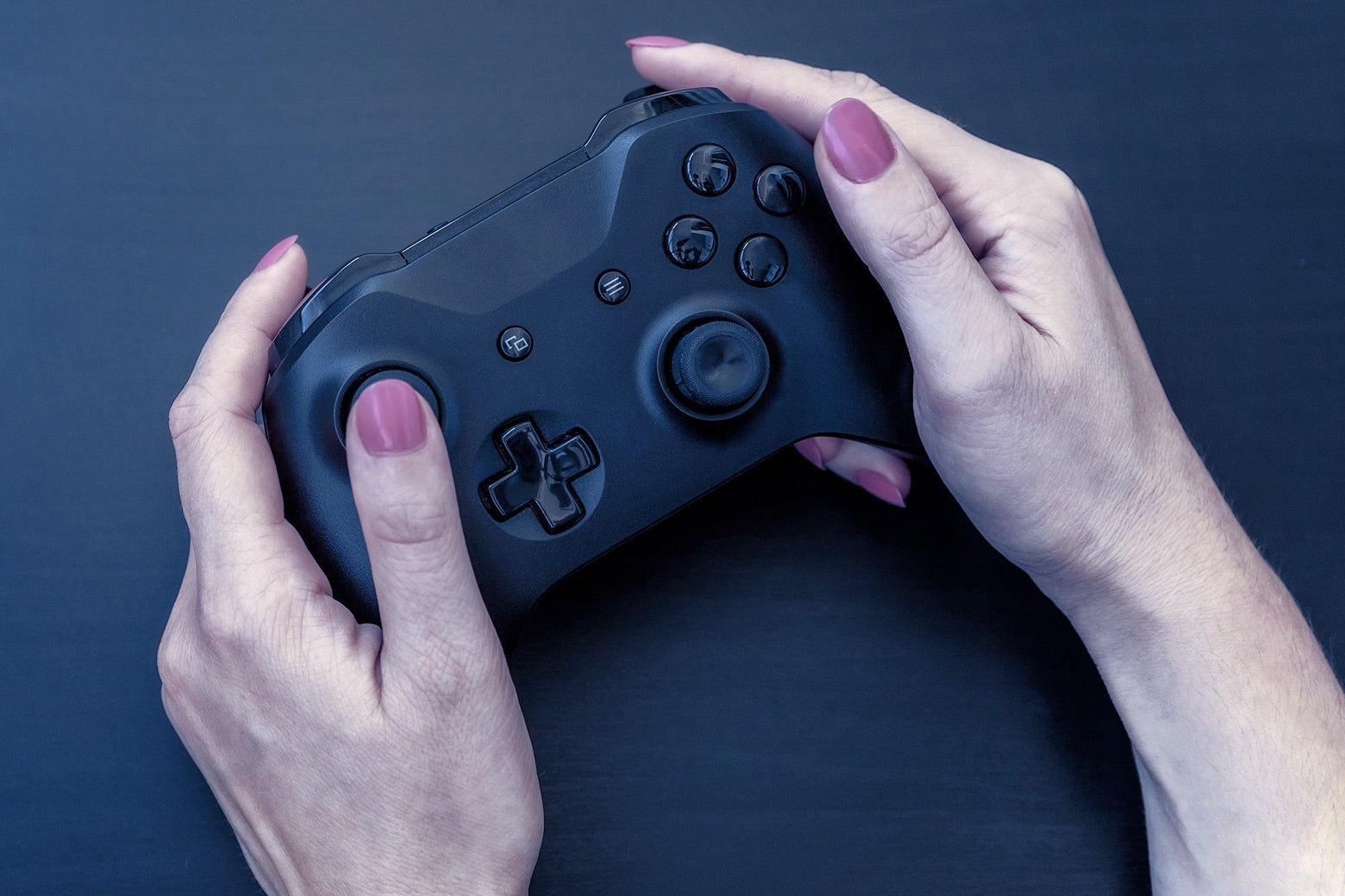 A woman holding a video game controller. 
