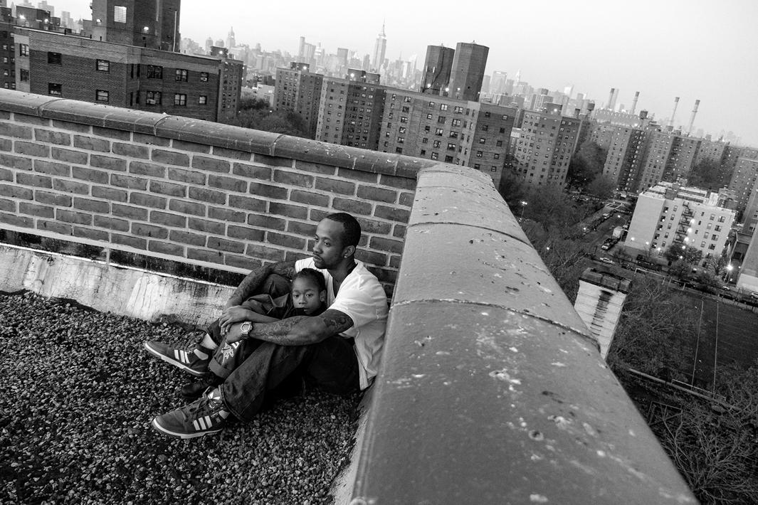 New York, New York, 2013. Jerell Willis and son Fidel on the rooftop of their apartment building.