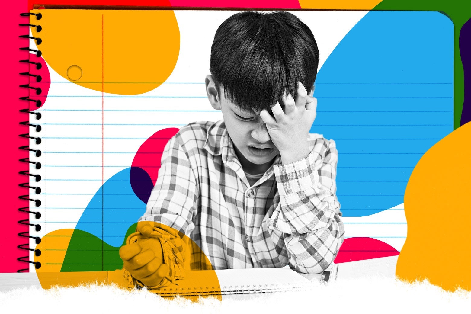 A boy scratches his head as he gets irritated doing his homework.