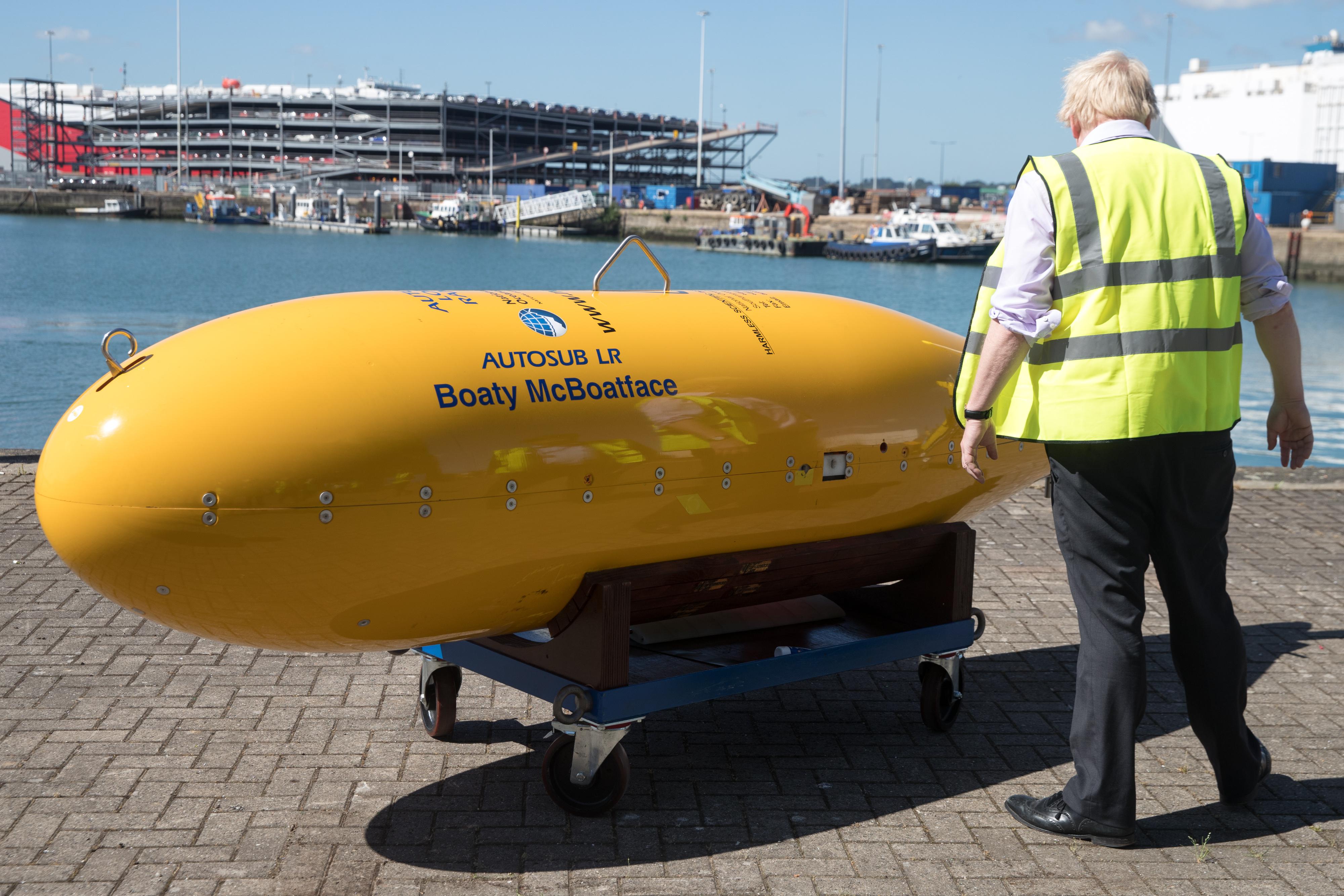A yellow submarine sits on a dolly, with the name Boaty McBoatface emblazoned on the side.