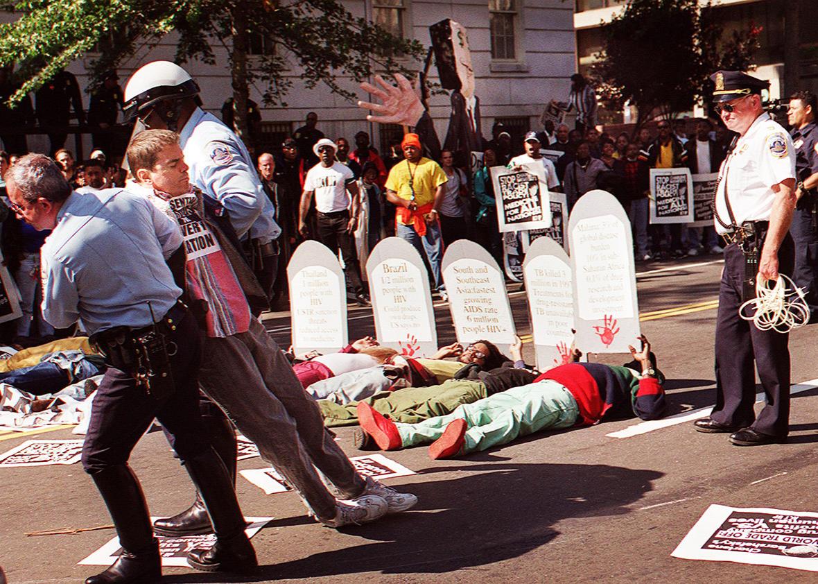 Washington DC police officers arrest an unidentified protester 06 October, 1999 during an ACT UP AIDS demonstration in front of the Offices of the US Trade Representative in Washington, DC. 