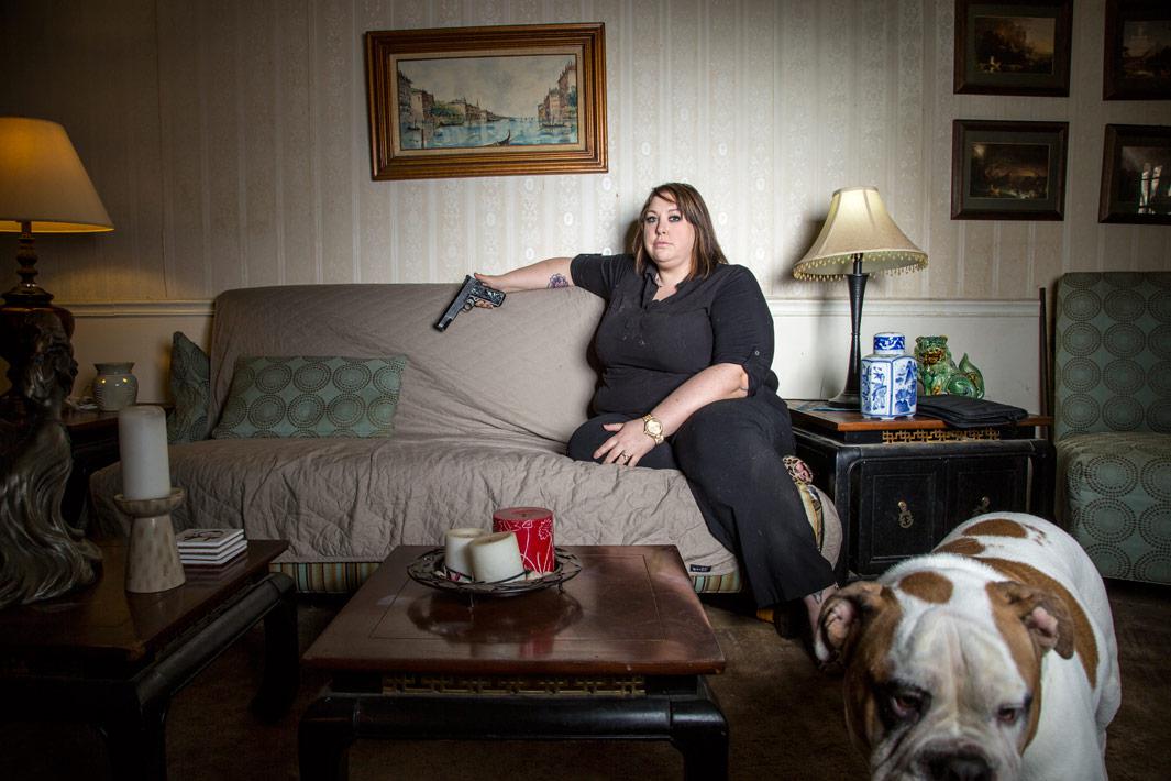 Lindsay Makowski in the living room of her home on Feb. 12, 2013, in Silver Spring, Md. Makowski now owns numerous guns after getting into a bad situation with a former boyfriend.