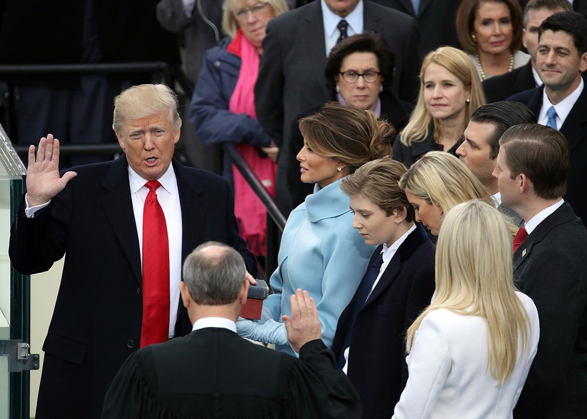 Supreme Court Justice John Roberts administers the oath of office to U.S. President Donald Trump  as his wife Melania Trump holds the Bible on the West Front of the U.S. Capitol on January 20, 2017 in Washington, DC. 