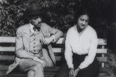 A still of a man and woman sitting together from Within Our Gates.