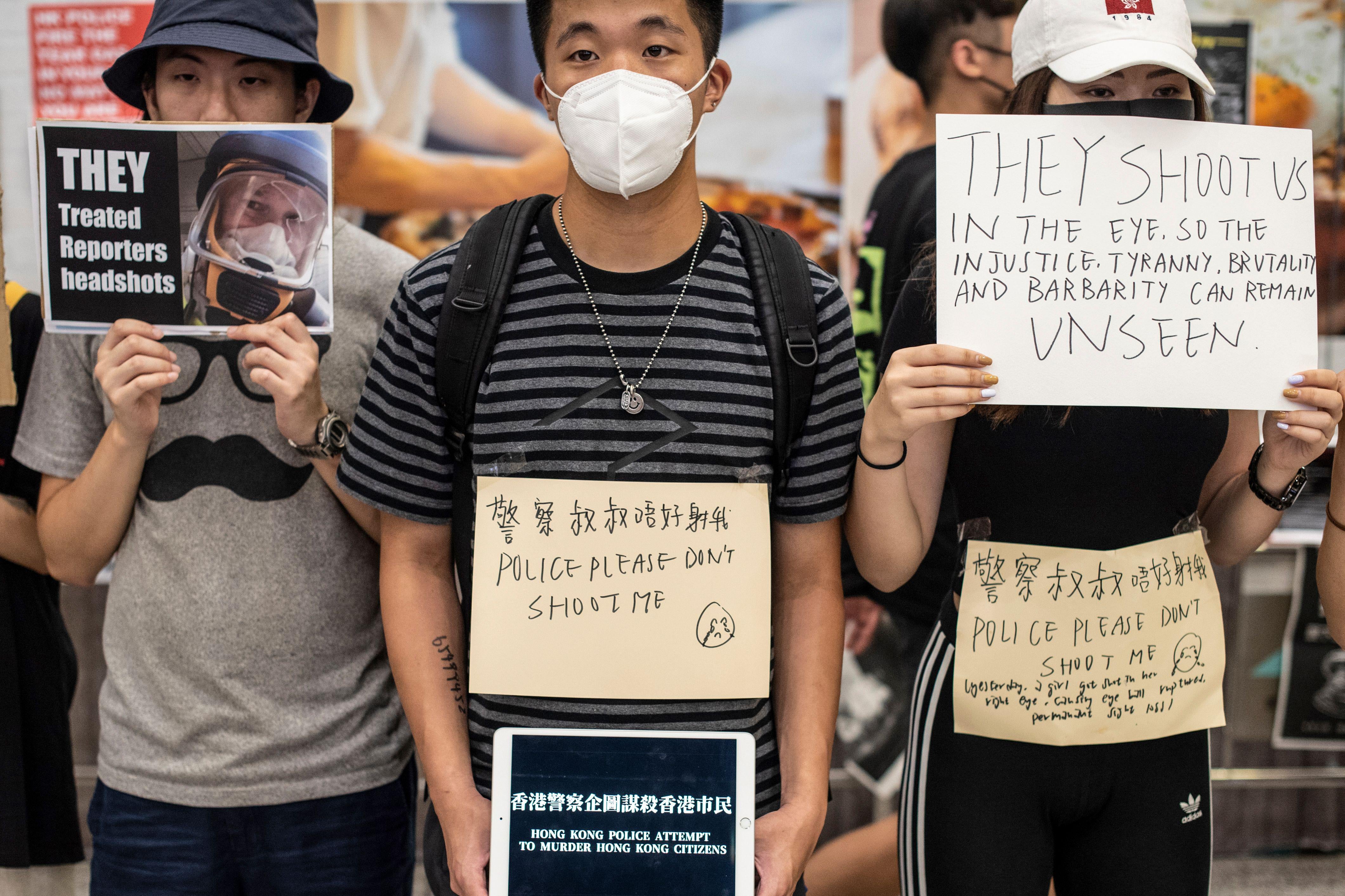 Protesters hold placards at Hong Kong's international airport.