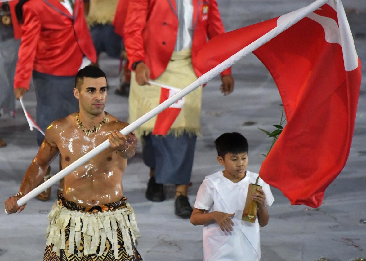 Tonga flagbearer Pita Nikolas Taufatofua leads his delegation during the Ol...