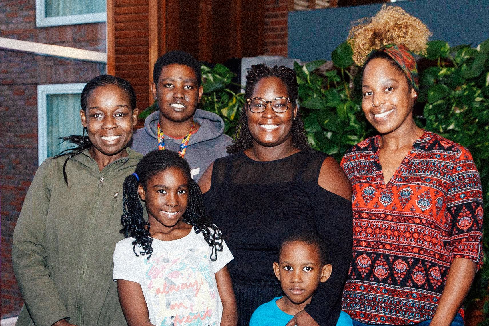 Gardite Fougy is pictured at center with her sister Stephanie Fougy (far left) and friend Aisha Baker (far right), and Fougy's three children: Myien, 14, Myiella, 9, and Gabriel, 6. 
