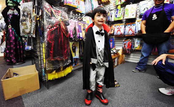 Four-year-old Rodney Lynch tries a 'dracula' outfit at a store.