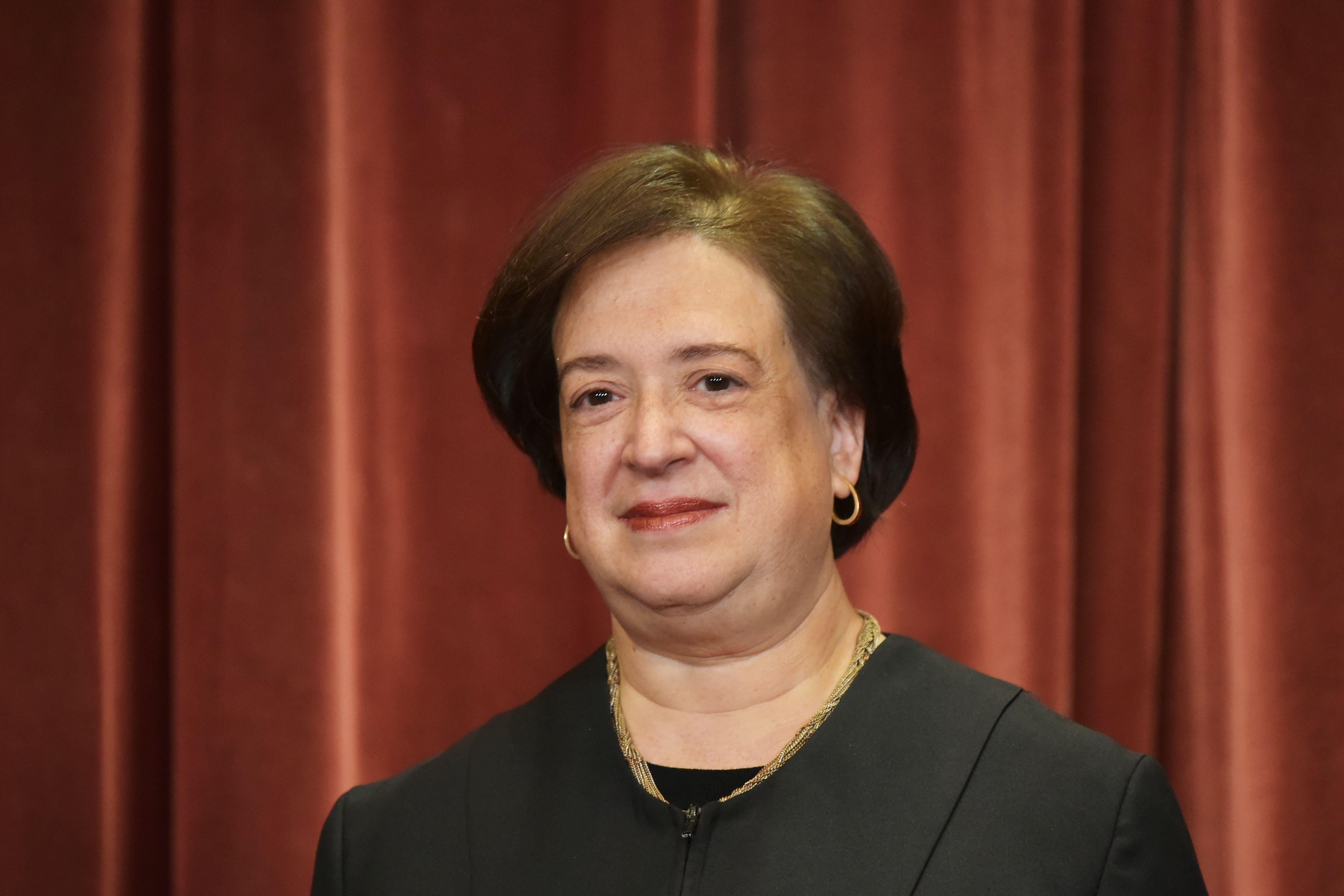 Justice Elena Kagan poses in the official group photo at the Supreme Court building.