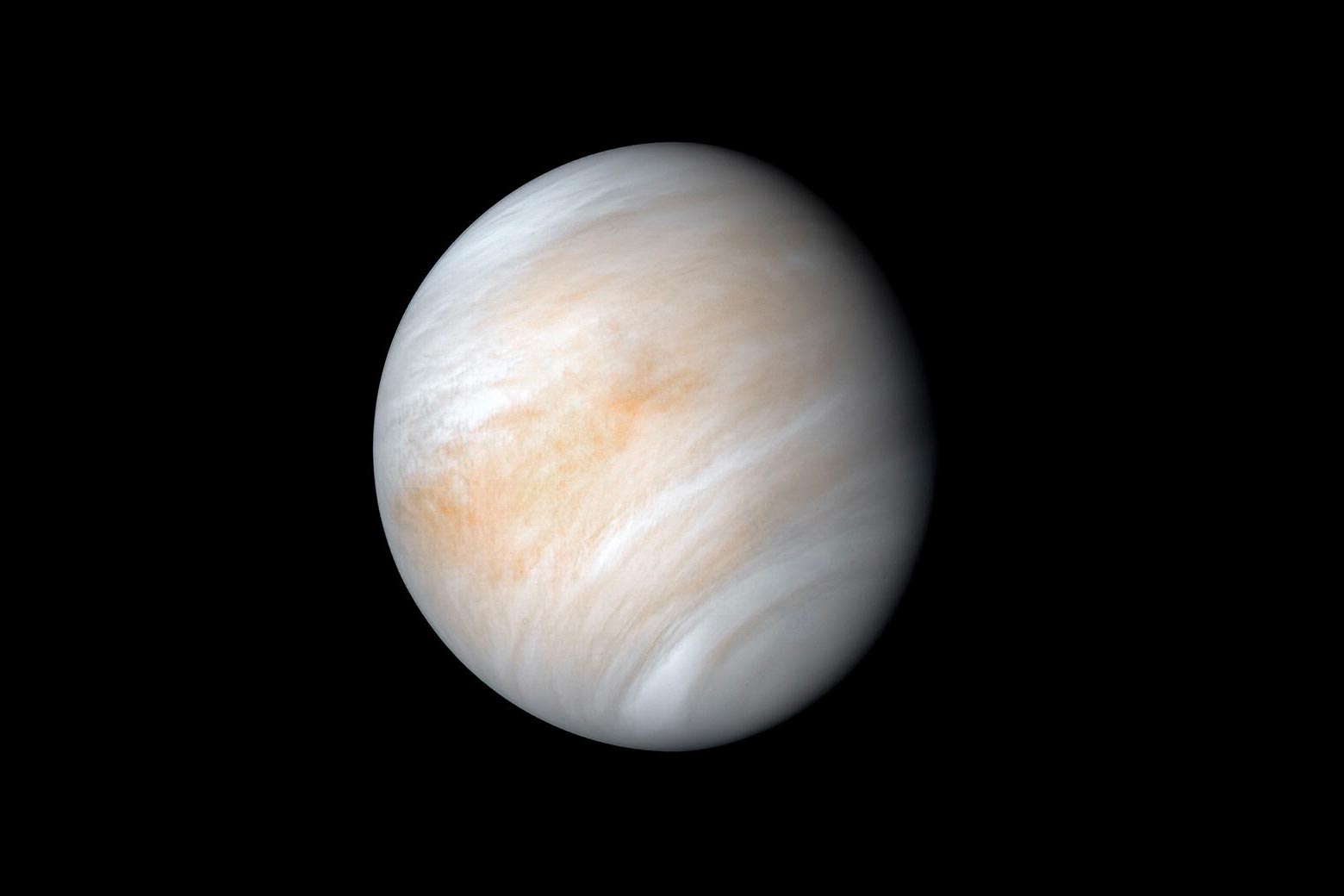 The planet Venus appears cloudy and tan on a black background