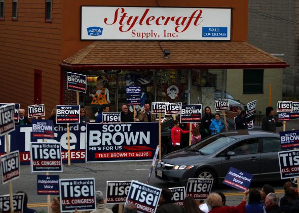 A car is flanked by campaign signs for Sen. Scott Brown and congressional candidate Richard Tisei outside of a campaign rally in Wakefield, Mass., on Nov. 1, 2012. 