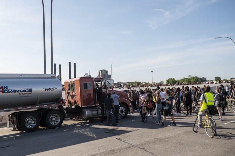 People react after a tanker truck drove into a crowd peacefully protesting the death of George Floyd on the I-35W bridge over the Mississippi River on May 31, 2020 in Minneapolis, Minnesota. 