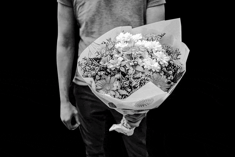 GIF of person holding a bouquet with flashing neon outlines of other men.