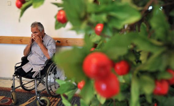 Kadyrbek Nurtazinov, 58, sits in a retirement home as he lost both of his legs because of radioactive irradiation, in Semipalatinsk, Kazakhstan.