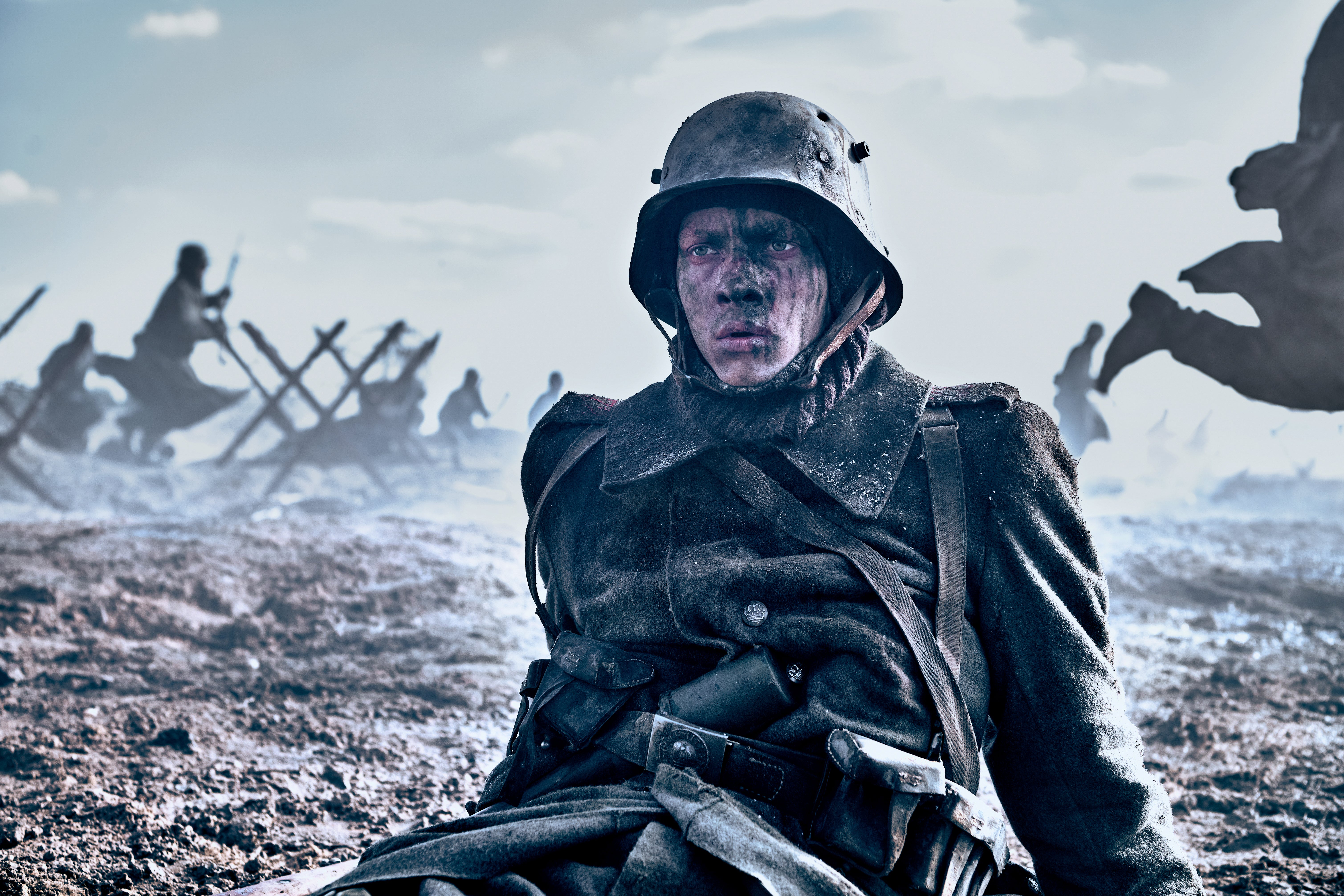 An ash-covered and ashen-faced soldier slouches on the battlefield in No Man's Land, staring a thousand yards in the distance