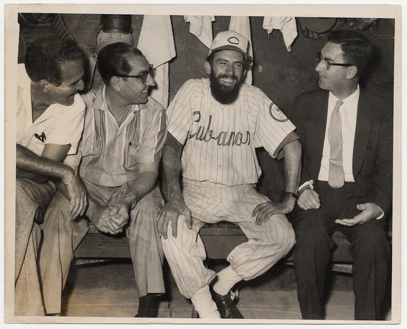 Camilo Cienfuegos, Cuban Guerilla Commander, wearing a Cubanos b,Camilo Cienfuegos, Cuban Guerilla Commander, wearing a Cubanos baseball uniform, 1959.