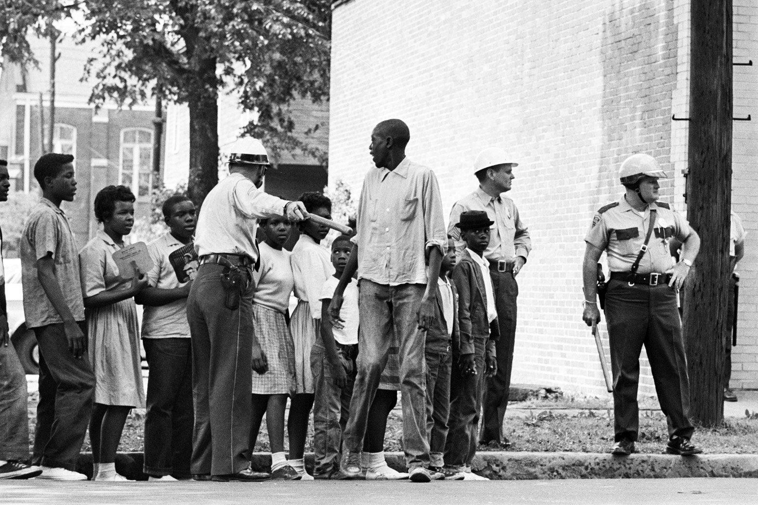 Children participating in a civil rights protest wait for a police van to take them to jail in Birmingham, Alabama, in 1963.
