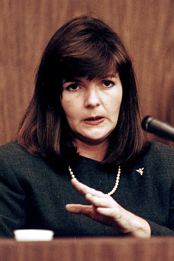 Patricia Bowman gestures while speaking into a microphone on the witness stand.