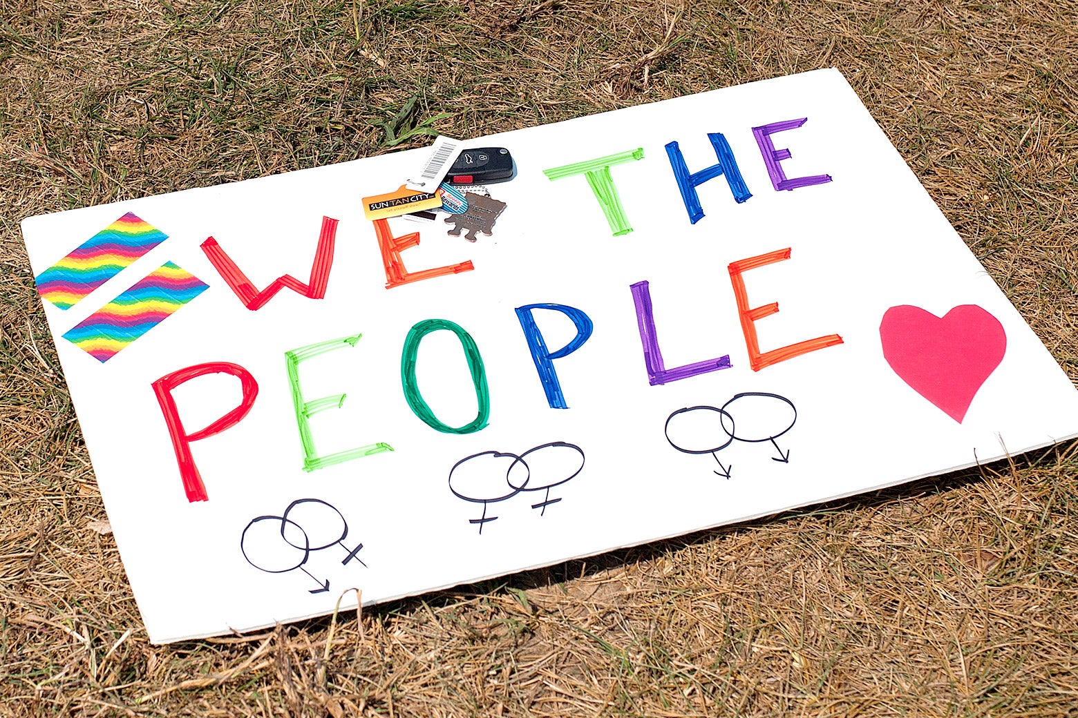 A sign supporting same-sex marriage ("We the People" with rainbow-colored lettering, a heart, and intertwined female symbols) lies on the ground in front of the Rowan County Courthouse on Sep. 2, 2015, in Morehead, Kentucky.