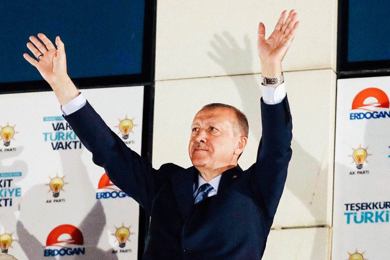 Arms outstretched in a double wave, Turkish President Recep Tayyip Erdogan greets his supporters gathered in front of the AKP headquarters in Ankara on Monday.
