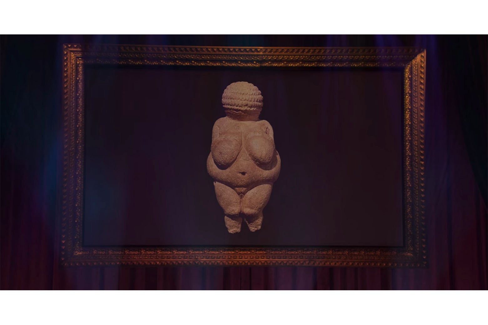 A projection screen from Douglas displaying an image of a paleolithic Venus figurine.