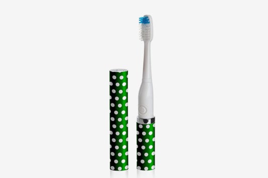 Green Violife toothbrush with white polka dots.