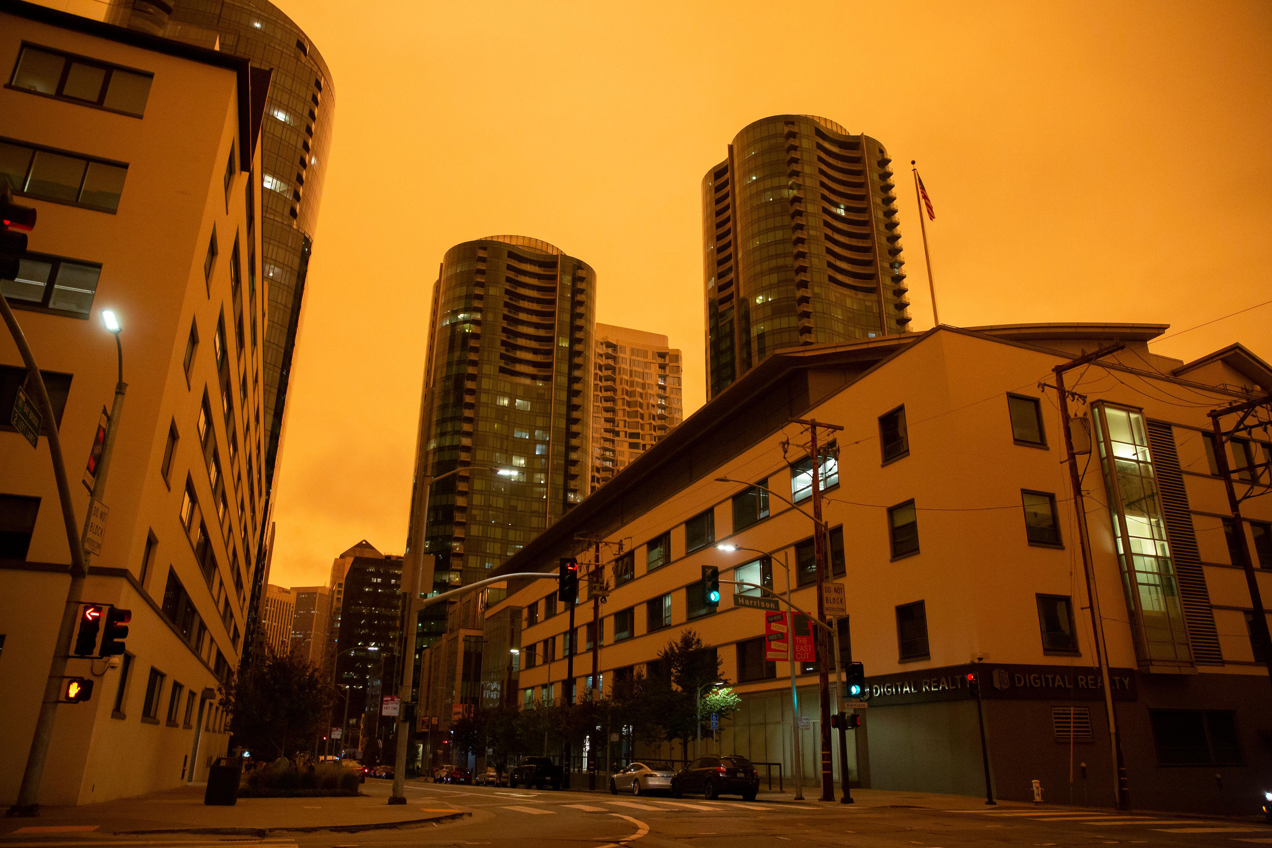The Infinity Towers are seen under an orange smoke-filled sky.
