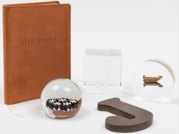 Paperweights and a leather journal. 