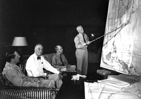 FDR in conference with Gen. D. MacArthur, Adm. Chester Nimitz, Adm. W. D. Leahy, while on tour in the Hawaiian Islands in January 1944.