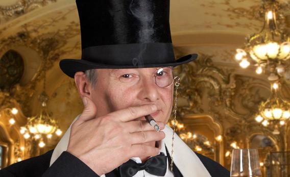 Man in a tux wearing a monocle.
