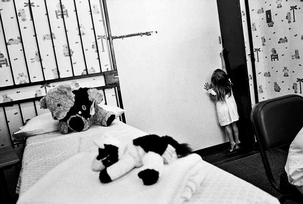 March 2003  / The Teddy Bear Clinic for Abused Children, Johannesburg, Gauteng A young girl attempts to flee a doctor’s room before a medical forensic examination. A nine-year-old relative who admitted to playing “sexual games” with her was later discovered to have been sexually abused himself. Both children were sent to counseling.