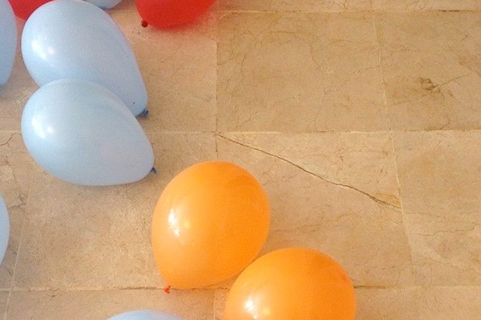 Balloons on the floor at the house.