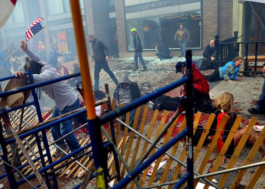 Destruction and injured people at the site of the one of the explosions that went off near the finish line of the 117th Boston Marathon. 