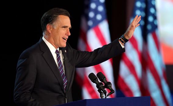 Mitt Romney, waves to the crowd while speaking at the podium as he concedes the presidency.
