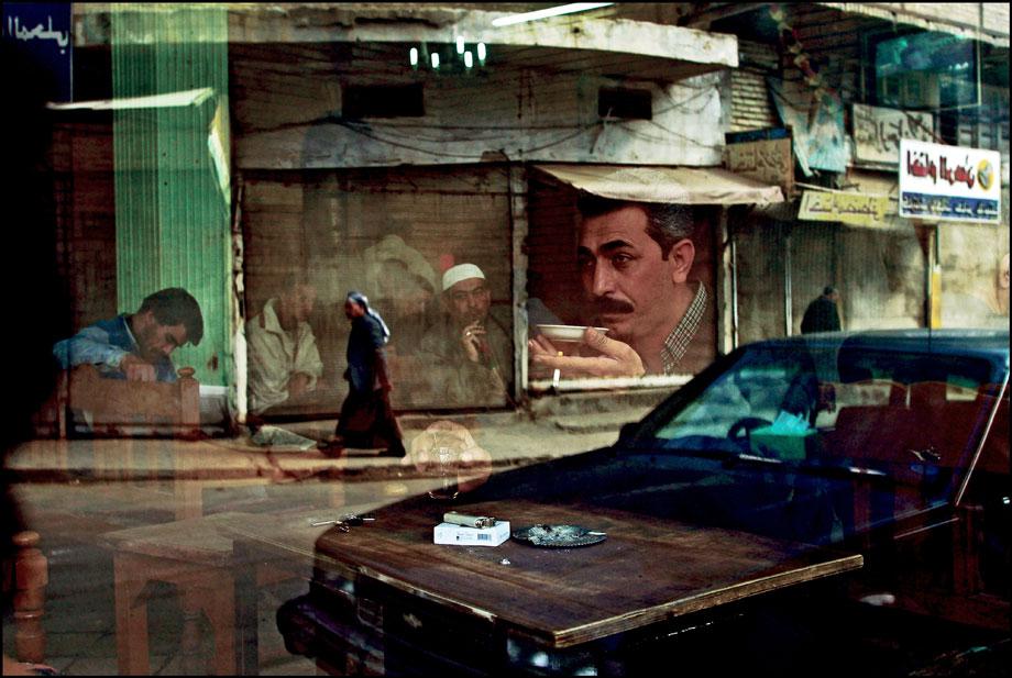 BAGHDAD—Six weeks before the start of the war, a man sits drinking tea at the Al Zahawi cafe on Rashid Street. Cafes are a trademark of this ancient city, gathering places where men socialize and play dominoes and blackjack, Feb. 12, 2003.