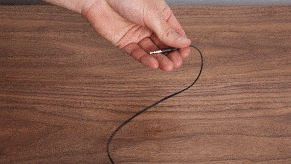 someone wrapping up a headphones cord