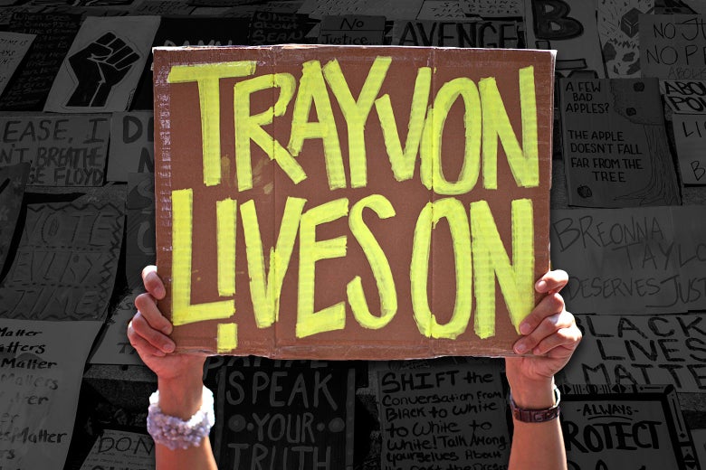 A protester holds up a sign that says, "Trayvon lives on." A collage of other protest signs is visible in the background.