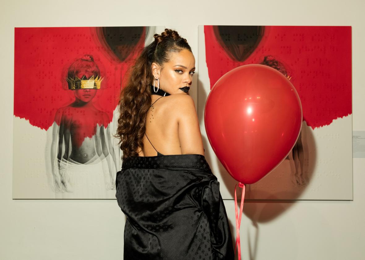 Rihanna poses with the album artwork for Anti.