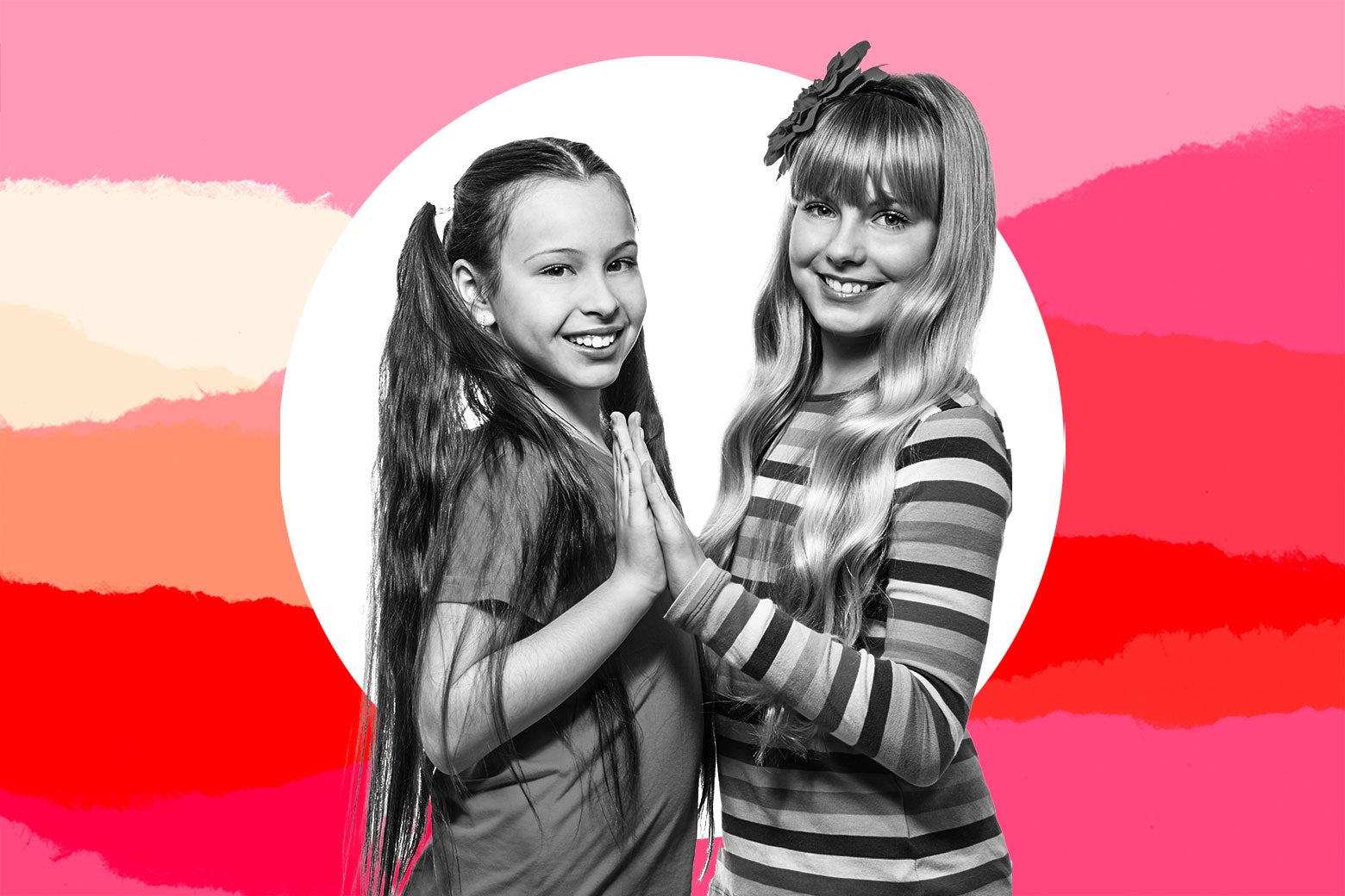 Two tween girls playing a hand game and smiling.
