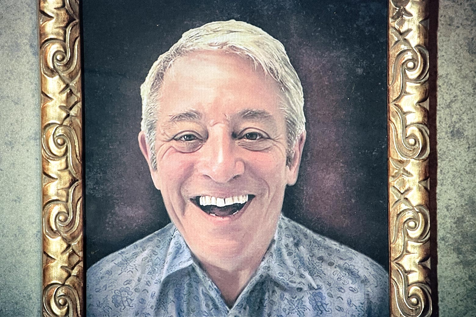 Photo of a smiling John Bercow, in an ornate gold frame.