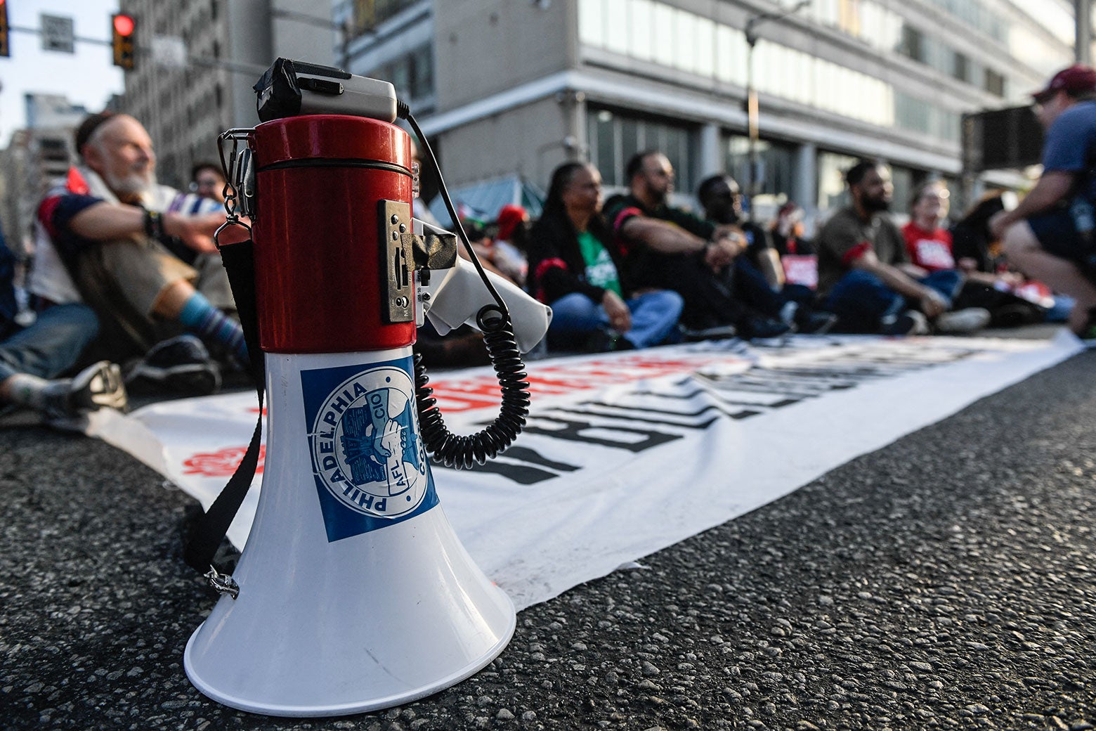 A megaphone with a sticker for the Philadelphia Council AFL-CIO union is seen near protesters gathered near Philadelphia City Hall during the "For the Workers, Not the Billionaires May Day Rally." 