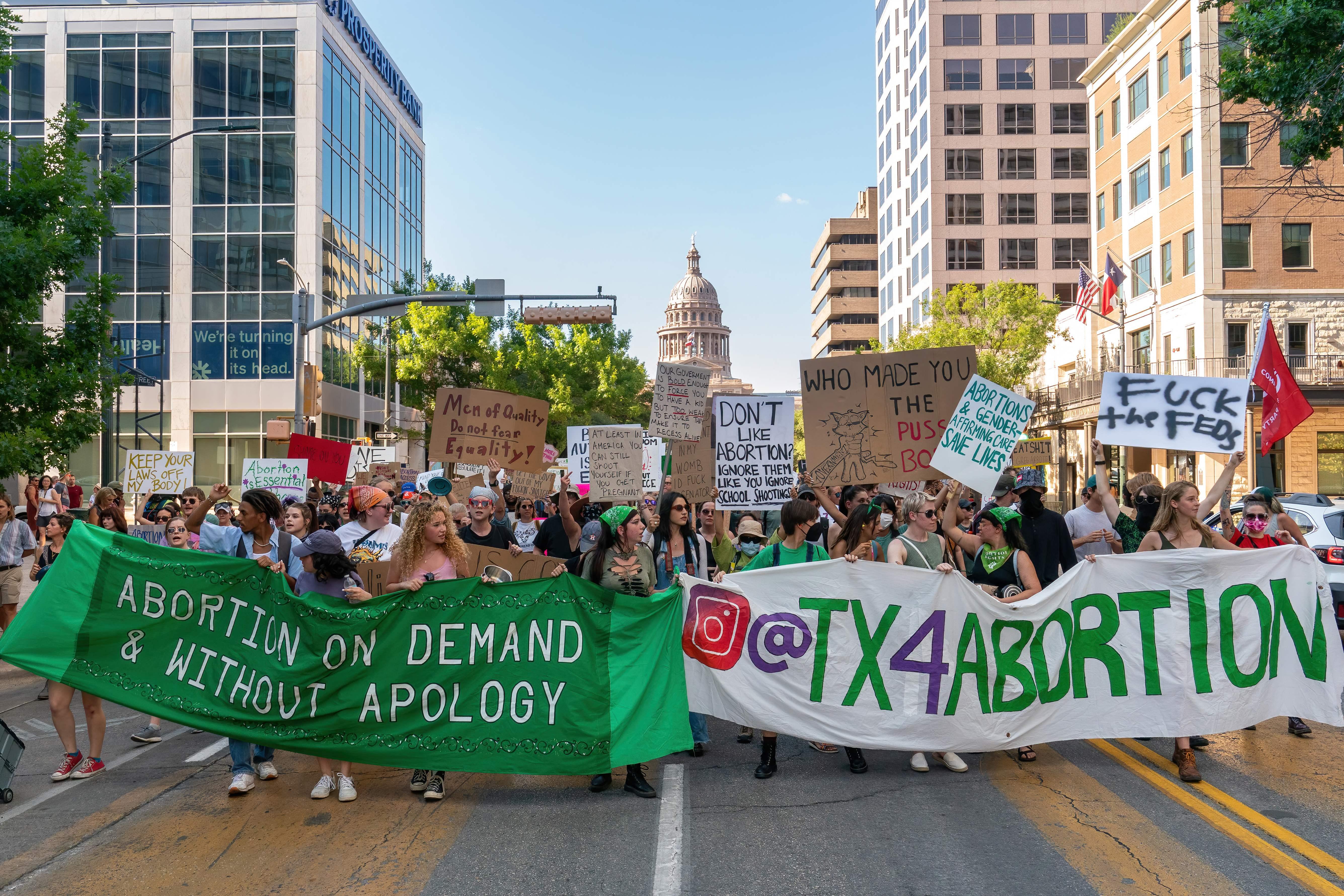 Abortion protesters fill the streets of Austin with signs like "Abortion on Demand & Without Apology."